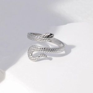 Macro shot of silver snake ring featuring detailed scales and adjustable open band design