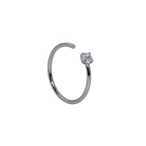 Detailed view of silver C-shaped nose ring featuring a round clear zircon stone