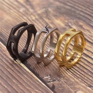 Detailed view of irregular rings with H letter cut-out in black, gold and silver finish