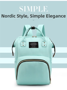 Detailed front view of mint green oxford fabric mummy backpack with spacious storage