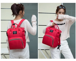 Red Oxford fabric diaper bag showing large capacity main compartment and side pocket
