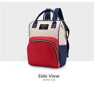 Micro side view of a large capacity oxford cloth diaper bag with red and blue color block