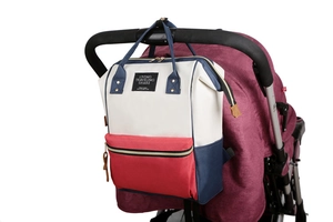 Detail view of the tricolor oxford diaper bag hanging on a stroller handle