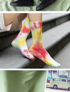Detail of vibrant tie-dye crew socks in red and orange gradient with ribbed texture