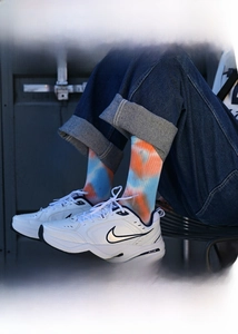 Macro view of tie-dye cotton mid-calf socks with orange and blue gradient knit texture