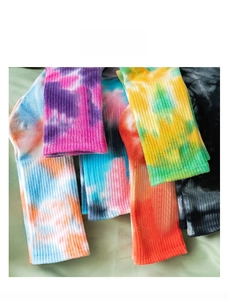 Detail of multicolor tie-dye crew socks with ribbed cuffs in various vibrant gradient patterns
