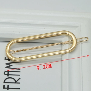 Minimalist gold alloy hair clip with long oval frame design measuring 9.2cm in length