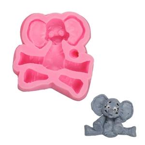 Detail of pink silicone elephant mold and grey animal fondant topper for DIY cake baking