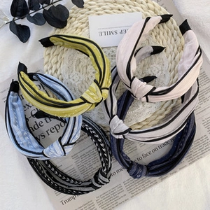 Detail of five knotted headbands in various colors including polka dots and stripes