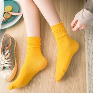 Breathable bright yellow velvet crew socks for women shown in a cozy lifestyle setting