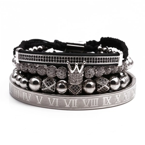 Detail of men's crown zircon charm with Roman numeral engraved metal ring on braided bracelet