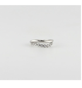 Macro view of a wave-shaped silver ring with sparkling side-stone pavé setting