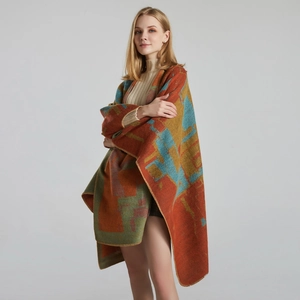 Detailed knit texture of colorful geometric pattern shawl with warm thick fringe