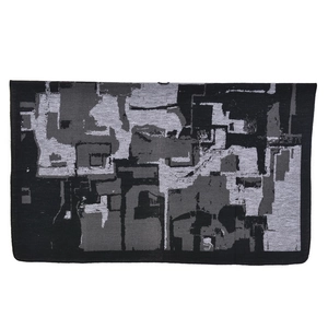 Close-up of jacquard woven fabric showing abstract geometric pattern in black and grey