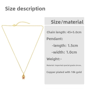 Detail of 18K gold plated cartoon boy pendant with white and red cubic zirconia