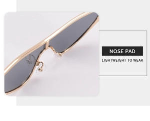 Detailed close-up of adjustable nose pads on lightweight gold metal triangle sunglasses