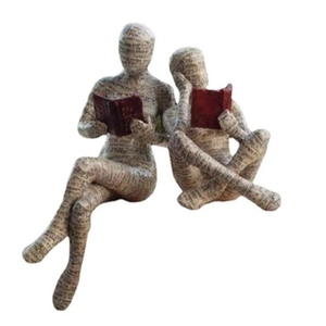 Artistic pulp paper reading woman and child sculpture with Hebrew text patterns