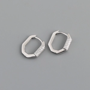 Detail of silver octagonal hoop earrings with sparkling cubic zirconia and polished finish