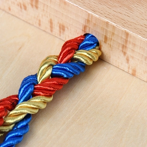 Three-strand braided rope for Montessori practice in vibrant red, blue and gold colors