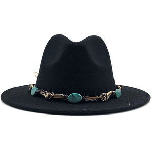Close-up of black fedora hat featuring a bohemian band with turquoise stone accents