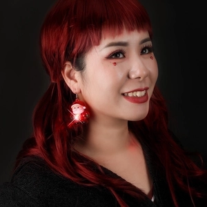 Luminous Santa Claus earrings with LED lights for Christmas parties on female model