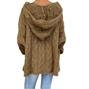 Detail of the chunky cable knit texture on the back of a brown hooded cardigan sweater