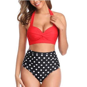 Retro push-up bikini set featuring a red halter top and black polka dot high-waisted bottoms