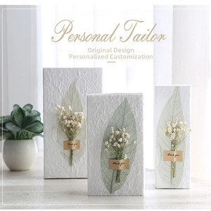 Macro detail of European wedding gift bags featuring dried flowers and thank you stickers