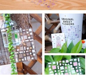 Artistic layout of geometric washi stickers in purple and green on a wooden surface