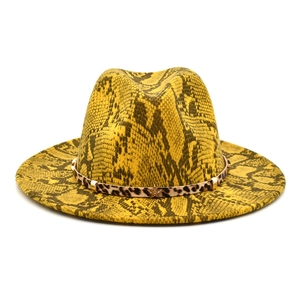 Detail of yellow snakeskin fedora hat with leopard print band and metal star rivets
