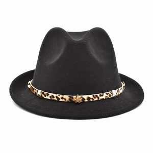 Black wool fedora hat with leopard print band and gold star ornament on white background