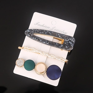 Three-piece hair clip set with resin acetate, faux pearls and colorful studs on white card