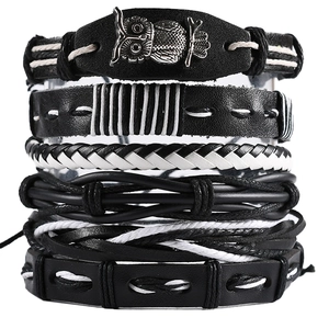 Detail view of a 6-piece stacked bracelet set featuring leather, owl charm and woven ropes