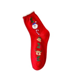 Festive red Christmas socks with knitted Santa Claus and reindeer cartoon patterns