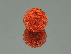 Macro shot of 10mm orange Shamballa pave crystal beads with dual holes for jewelry making