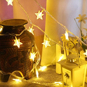 Star-shaped LED fairy lights emitting warm yellow light wrapped around decorative lanterns