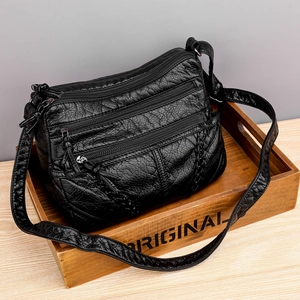 Black vintage soft leather crossbody bag with multiple pockets and adjustable shoulder strap