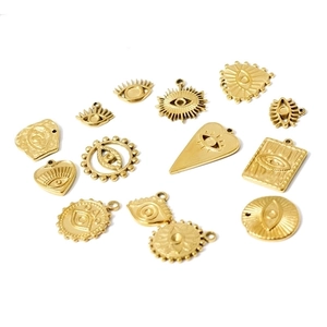 Set of 18k gold plated evil eye charms and pendants in various shapes on white background