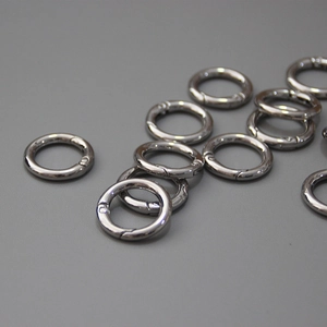 Macro view of gunmetal spring O-ring buckles for bags and DIY hardware accessories