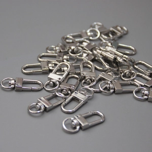 Macro view of polished silver lobster claw swivels for DIY handbag chains and accessories