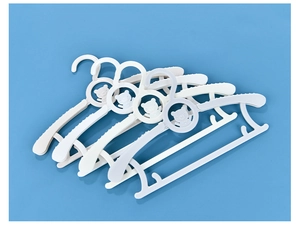 Close-up of white adjustable plastic hangers for kids with cute bear pattern details