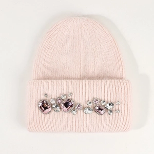Close-up of light pink angora rabbit fur knit hat with sparkling rhinestone details