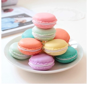 Close-up of colorful macaron-shaped mini jewelry storage boxes in various pastel colors