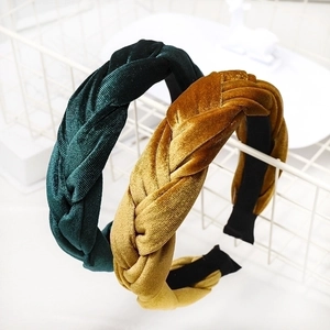 Braided velvet headbands in dark green and mustard yellow with twisted fabric design
