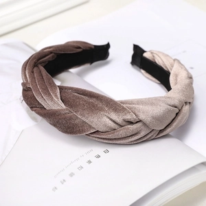 Detailed view of the woven brown velvet headband texture with a twisted braid pattern