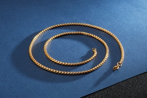 Detailed view of a gold stainless steel box chain necklace with a lobster clasp
