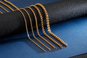 Detail view of five different widths of polished gold box chains for men and women