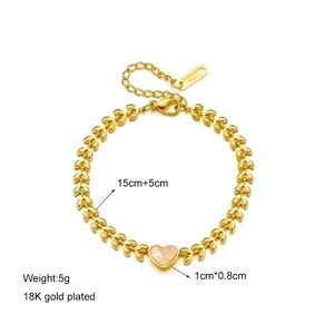 Macro view of 18K gold plated heart bracelet with shell texture and measurement data