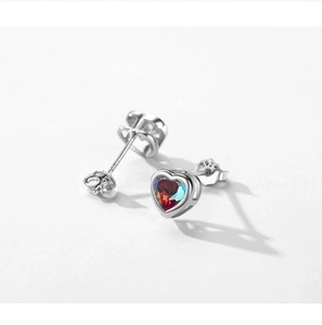 Macro shot of S925 sterling silver heart earrings with gradient cubic zirconia stones