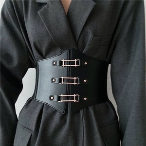 Vintage black elastic wide corset belt with triple gold buckles on a grey suit jacket